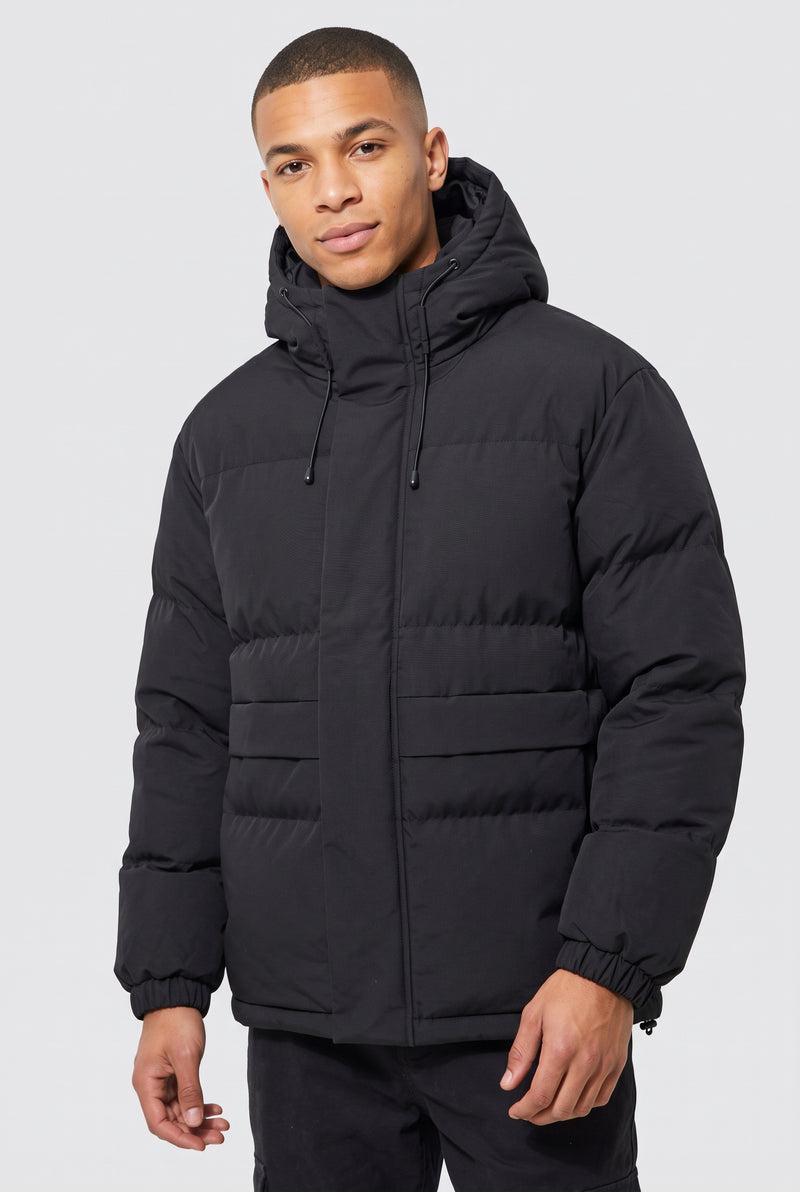 Matte Finish Hooded Puffer Jacket in Black — studio front