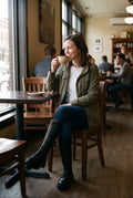 Women's Long Boots Modern in Black — lifestyle caf window