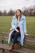 Women's Puffer Jacket Hooded in Blue — park bench lifestyle
