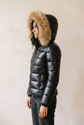 Glossy Puffer Jacket with Faux Fur Hood in Black — studio angle