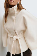 Belted High-Neck Cape Coat in White — front view