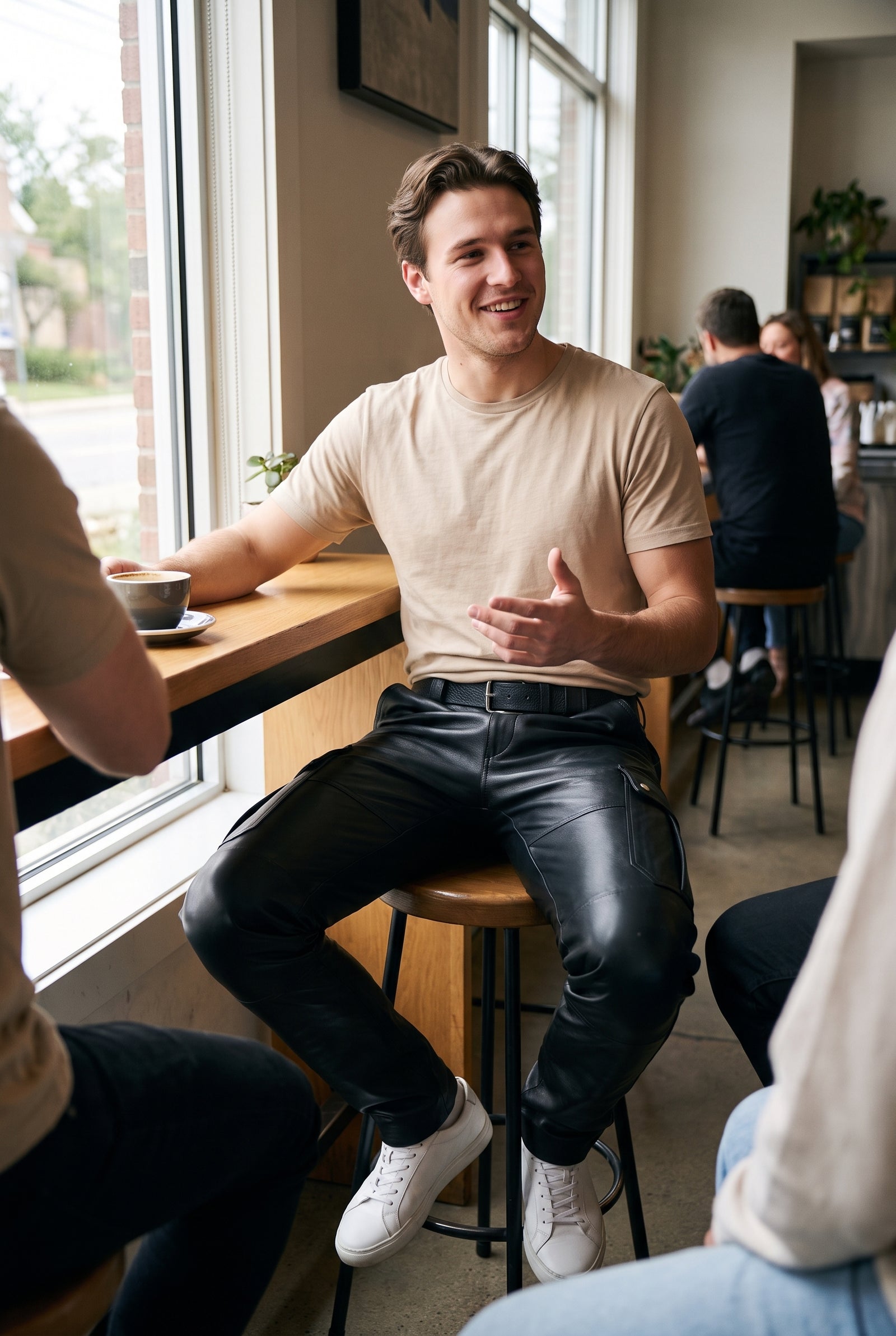 Men's Black Cargo Pants in Leather Look  — lifestyle cafe window