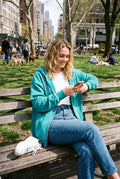Women's Hoodie Oversized Zipper in Aqua — park bench shot