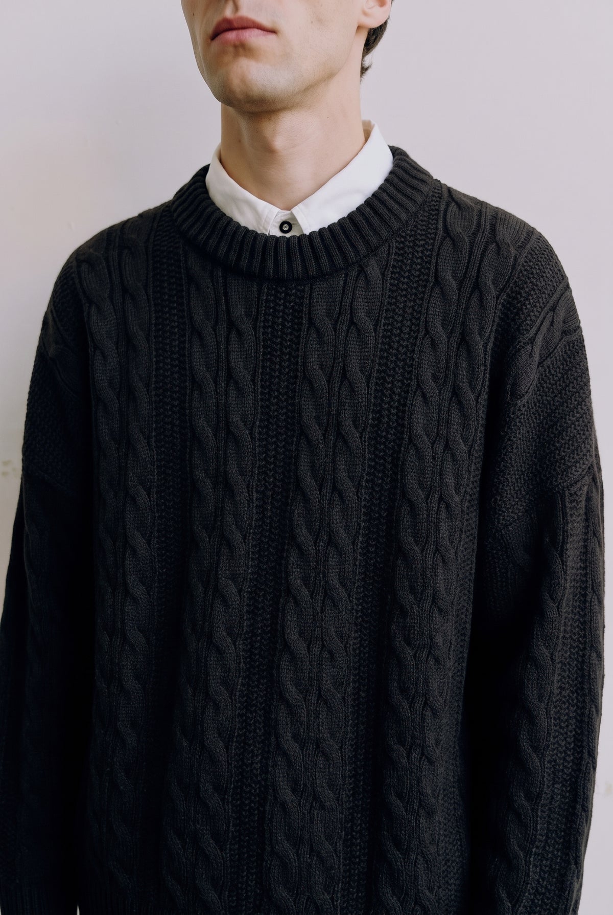 Cable-Knit Crewneck Sweater in Black — studio front