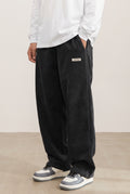 Corduroy Trousers with Drawstring in Black — studio front