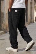 Corduroy Wide-Leg Pants in Black — studio front