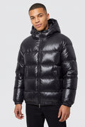 Glossy Hooded Puffer Jacket in Black — studio front