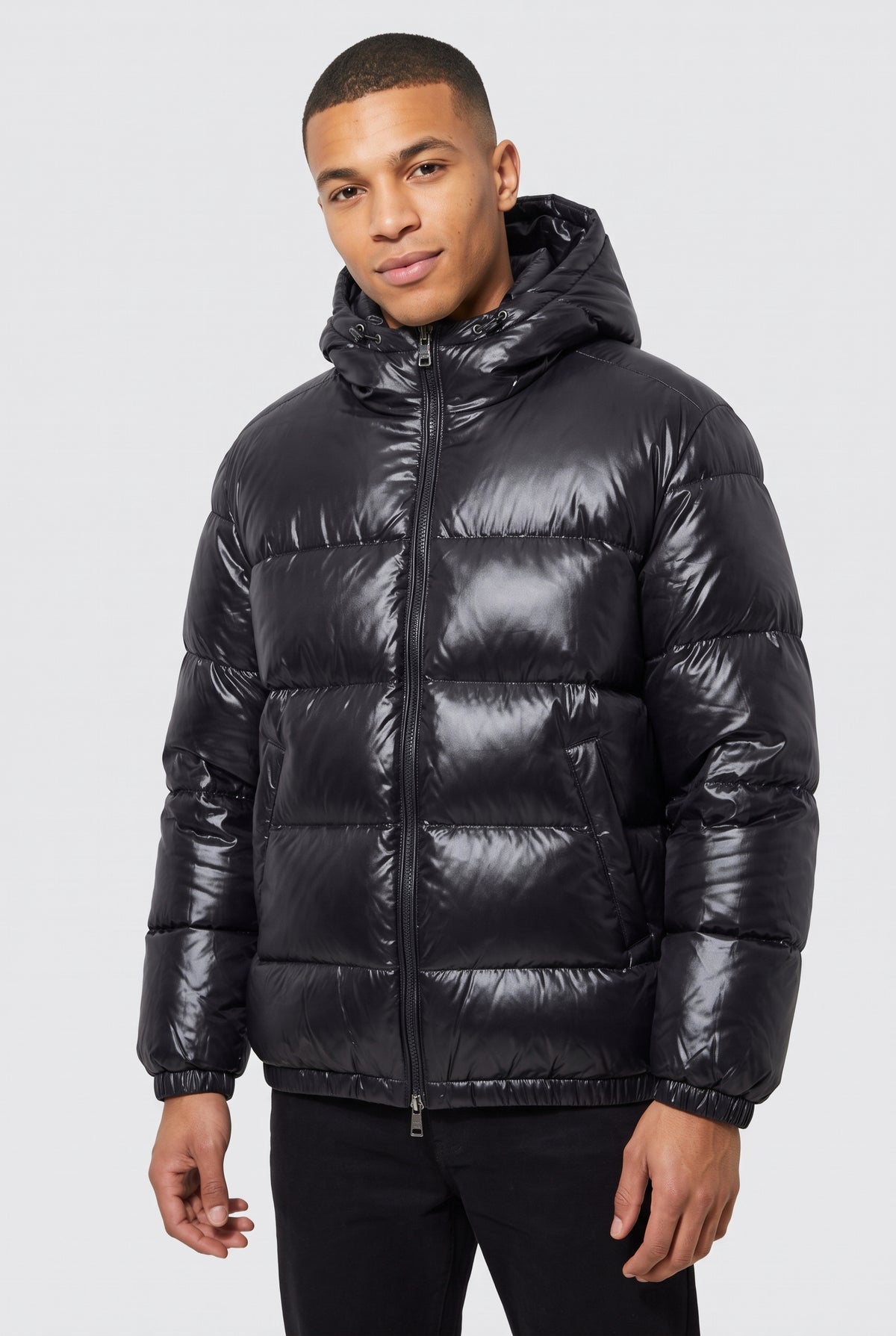 Glossy Hooded Puffer Jacket in Black — studio front