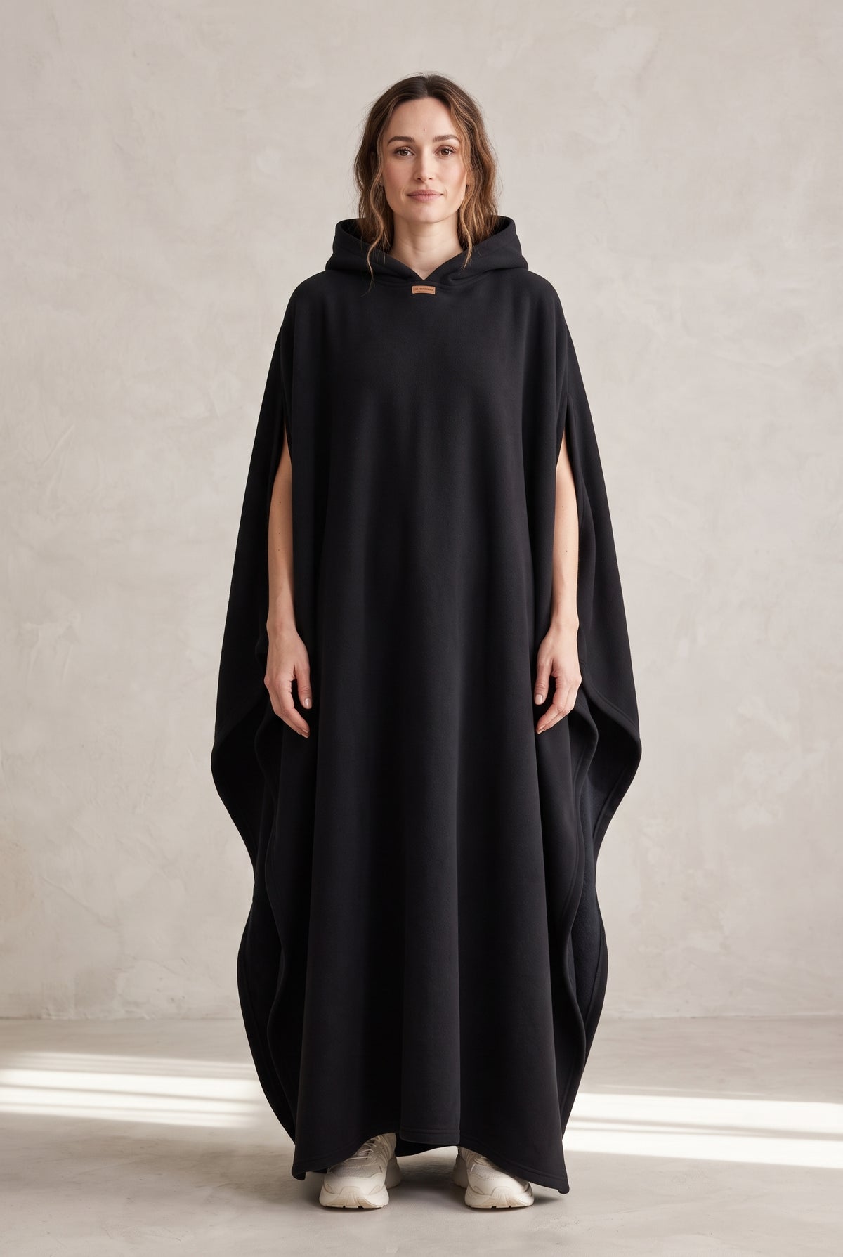 Hooded Cape with Wide Openings in Black — studio front