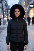 Hooded Faux-Fur Puffer Jacket in Black — studio front