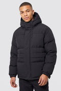 Matte Finish Hooded Puffer Jacket in Black — studio front