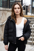 Quilted Hooded Puffer Jacket in Black — studio front