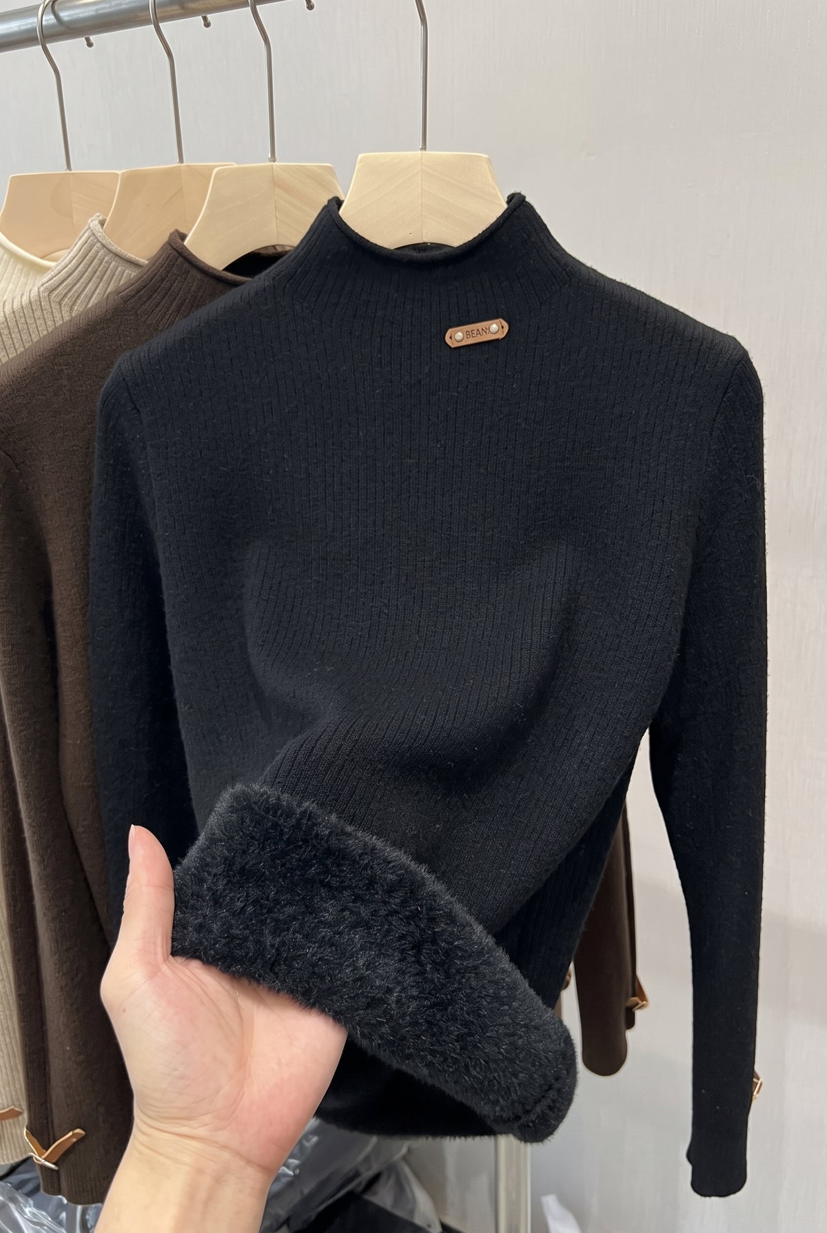 Ribbed High-Neck Sweater in Black — studio front
