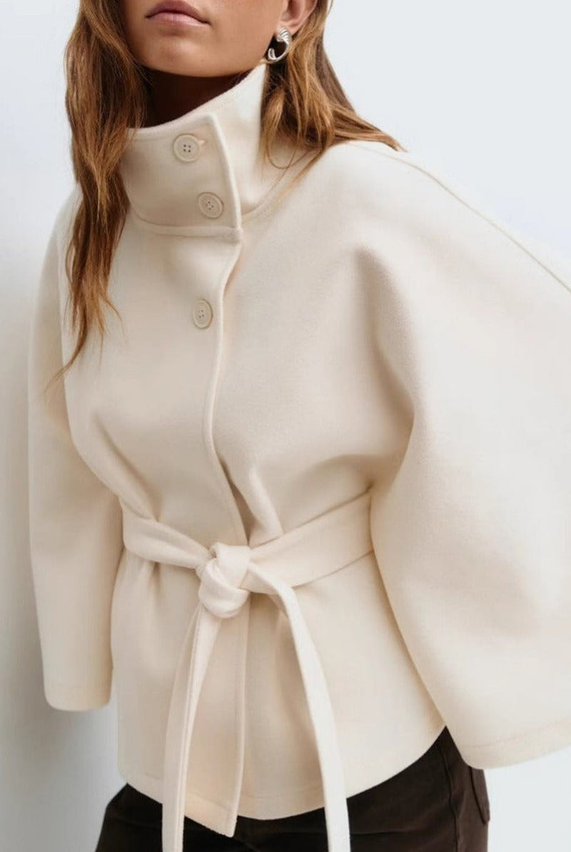 Belted High-Neck Cape Coat in White — front view