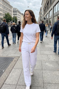 Women's Pants Relaxed Fit in White — urban sidewalk afternoon